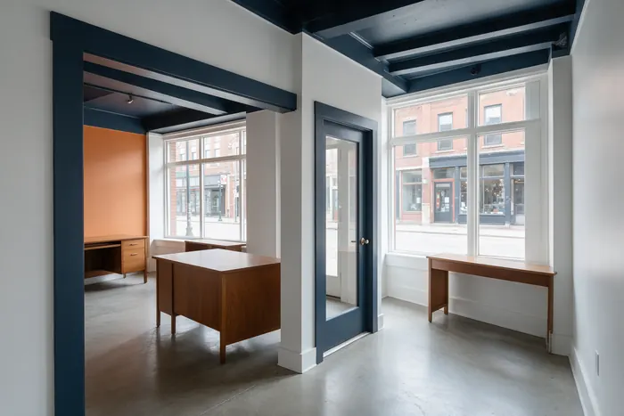 Freshly painted storefront office with a warm orange accent wall